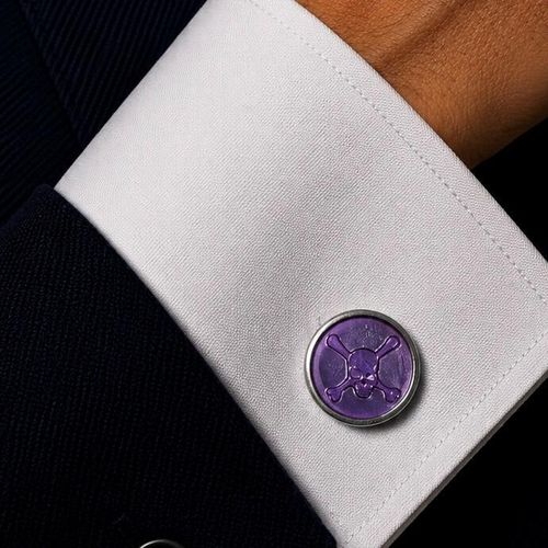 Pewter cufflinks with hand-enamelled purple skull design displayed with presentation gift box