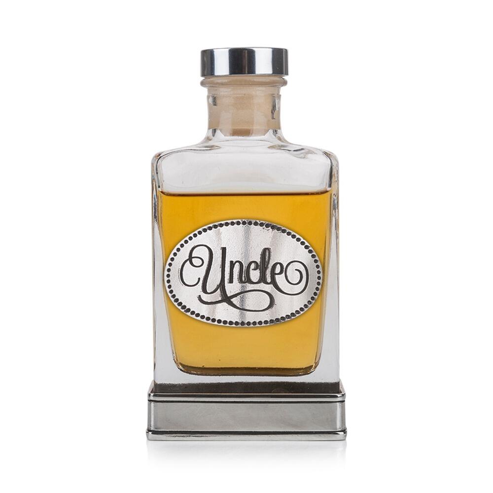 A glass flask with a pewter base and a handcrafted pewter “Uncle” emblem on the front