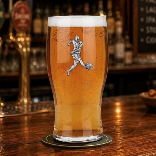 Pint glass with handmade pewter football player badge, filled with golden beer