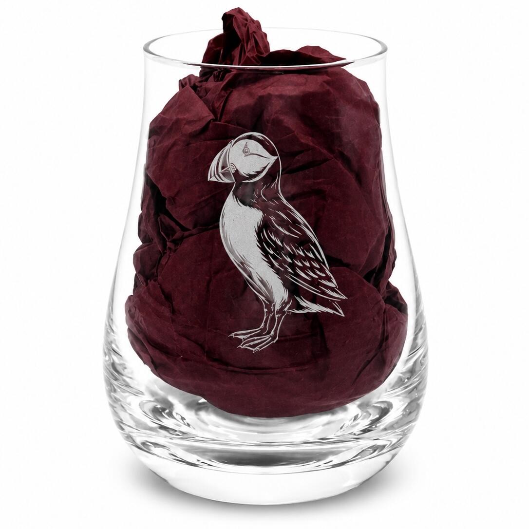 Close-up of puffin engraved whisky tasting glass with burgundy gift-box tissue