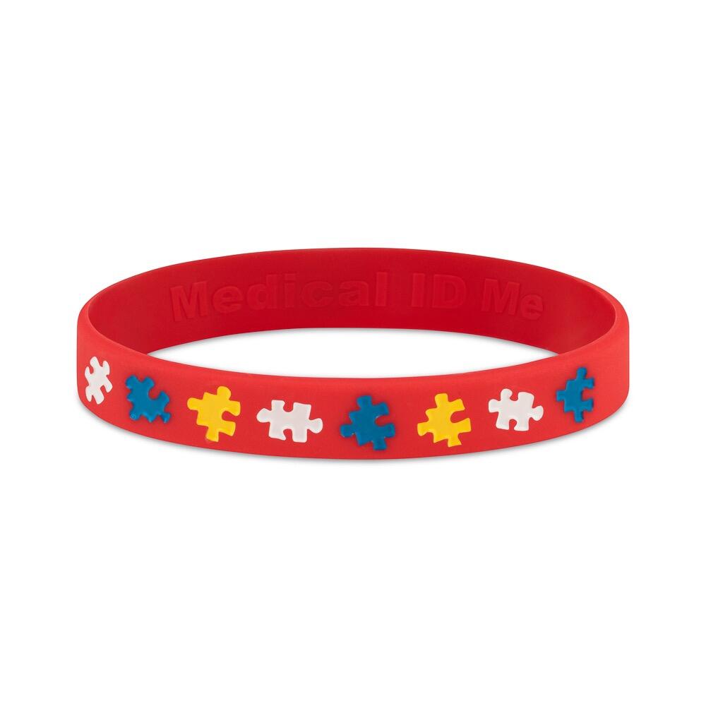 Red ADHD awareness marks bracelet featuring colourful puzzle piece symbols