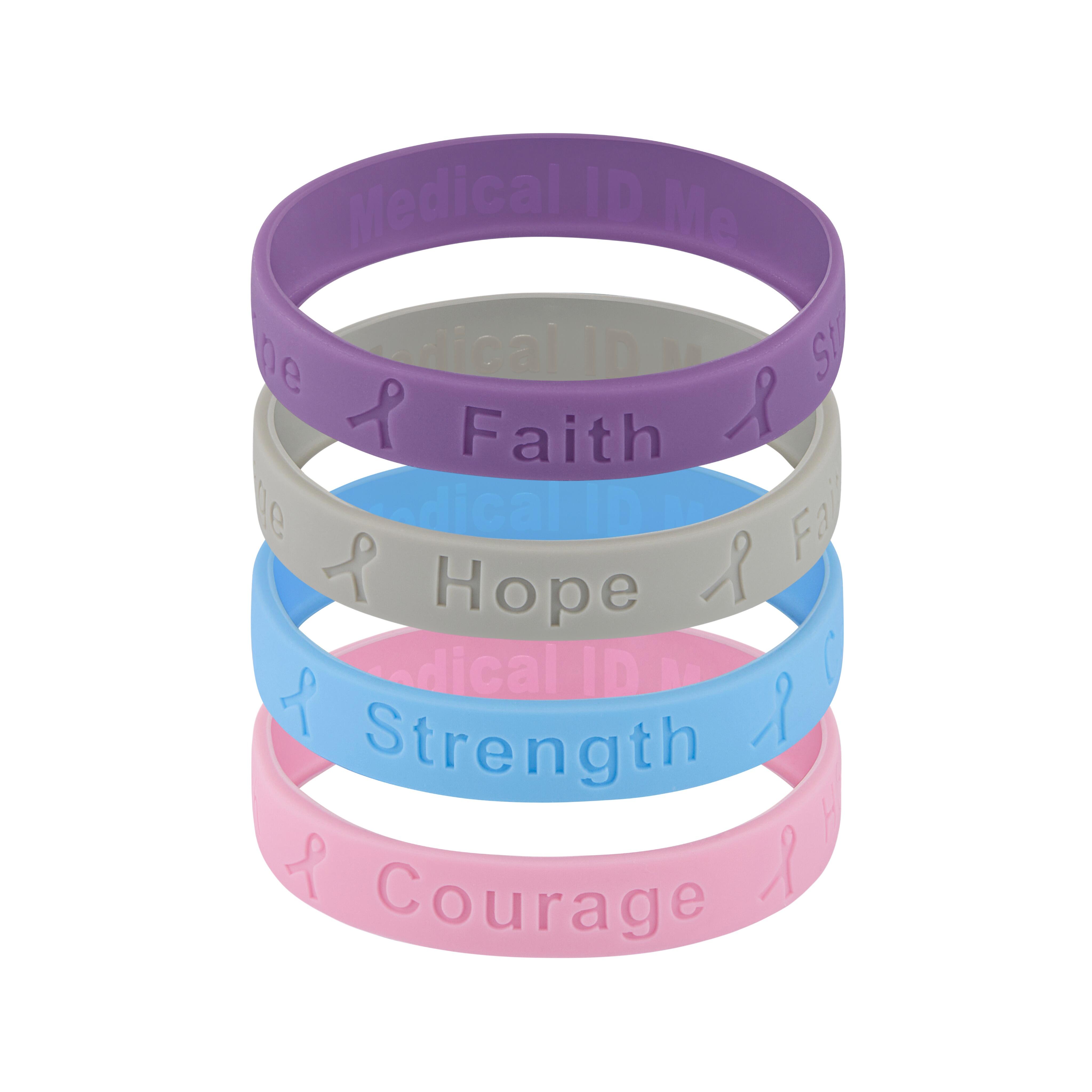 Stacked silicone cancer awareness bracelets in purple, grey, blue and pink displaying the words “Faith”, “Hope”, “Strength” and “Courage”.