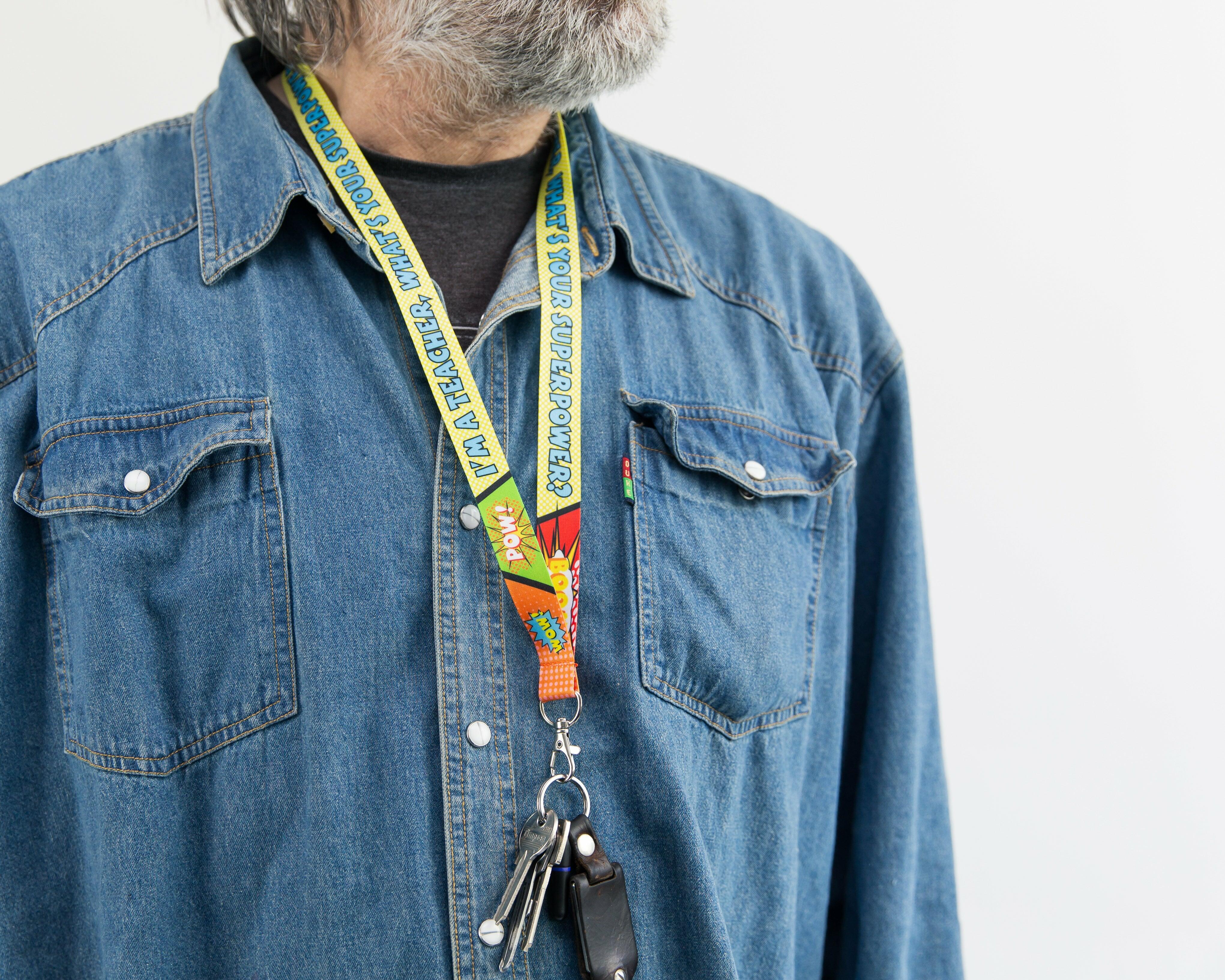 Male model wearing the ‘I’m A Teacher, What’s Your Superpower’ lanyard with keys attached