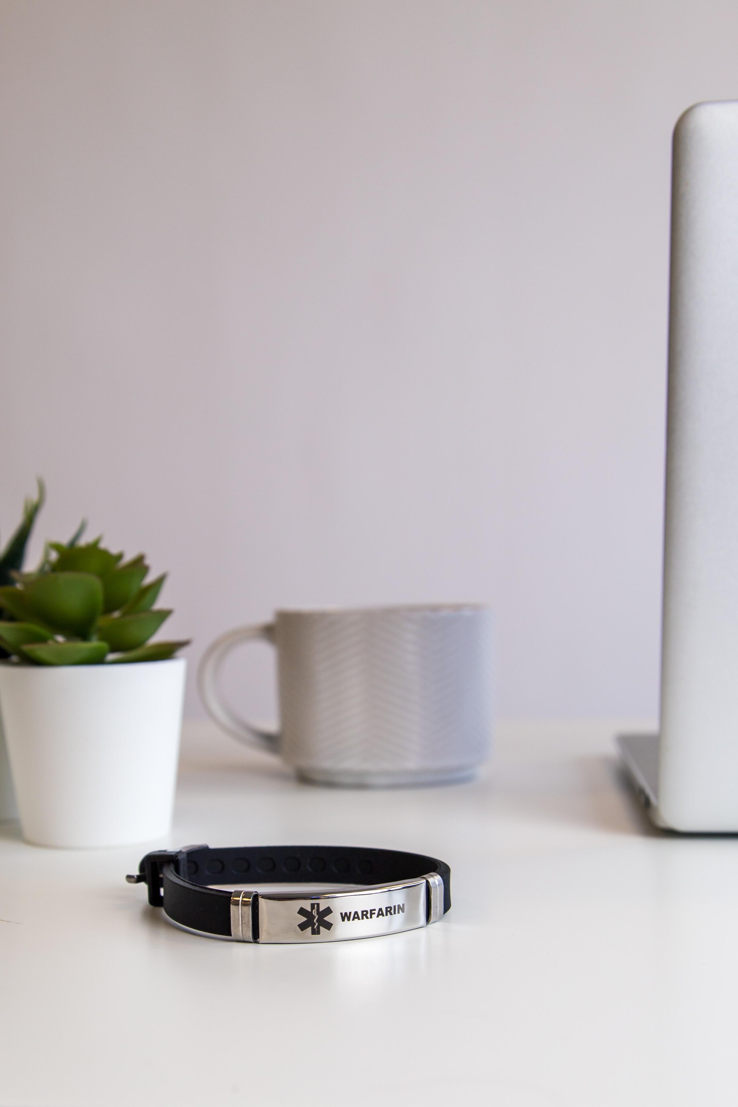 Warfarin adjustable medical ID bracelet displayed on a clean surface