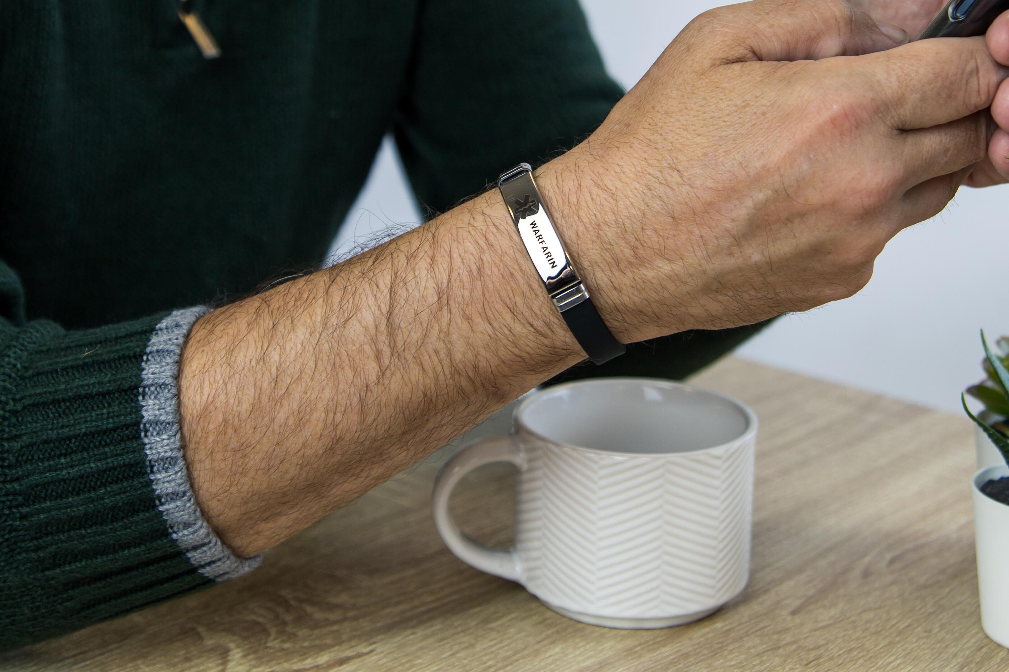 Person wearing Warfarin adjustable medical alert bracelet on wrist