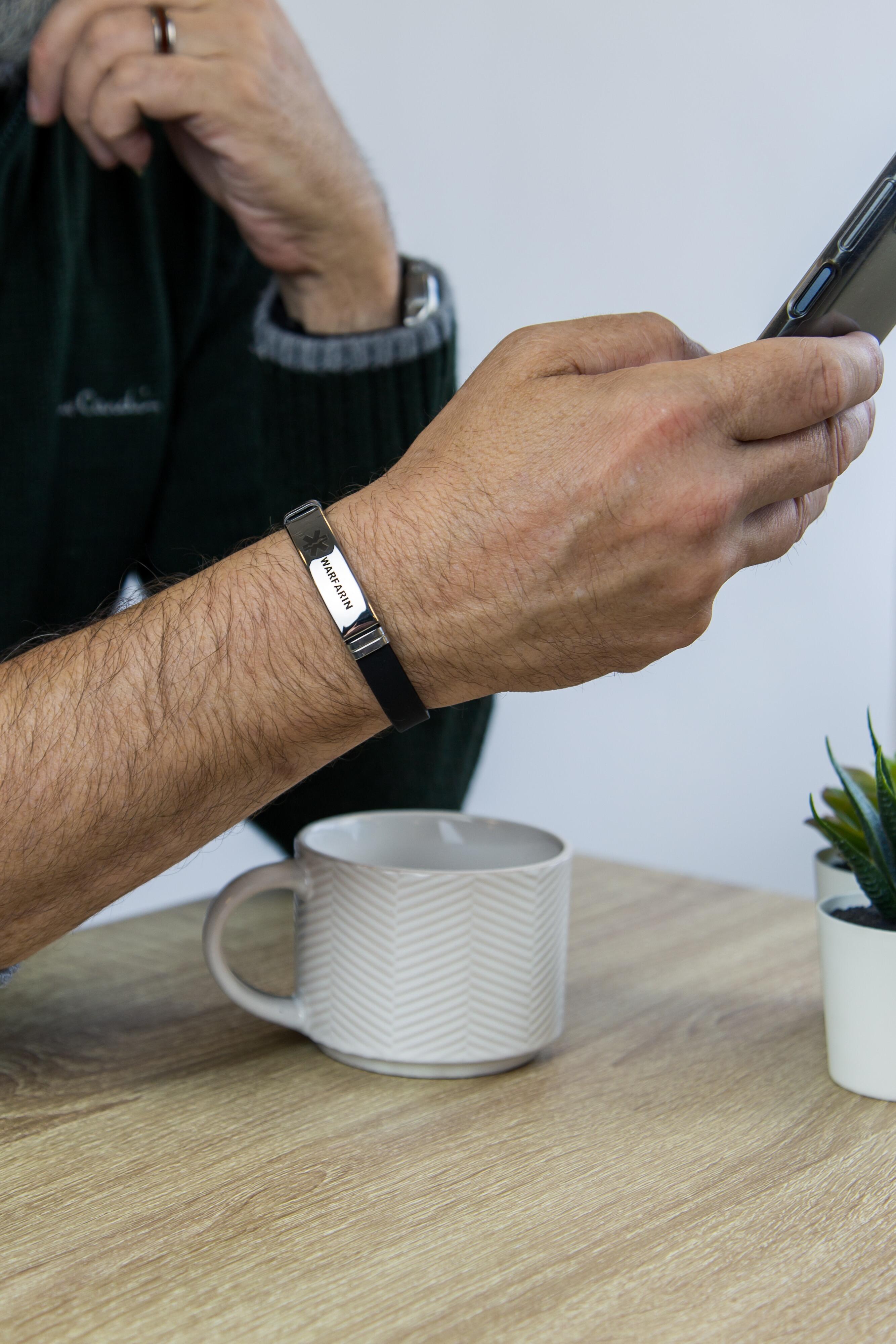 Close-up of Warfarin medical alert bracelet worn during everyday use