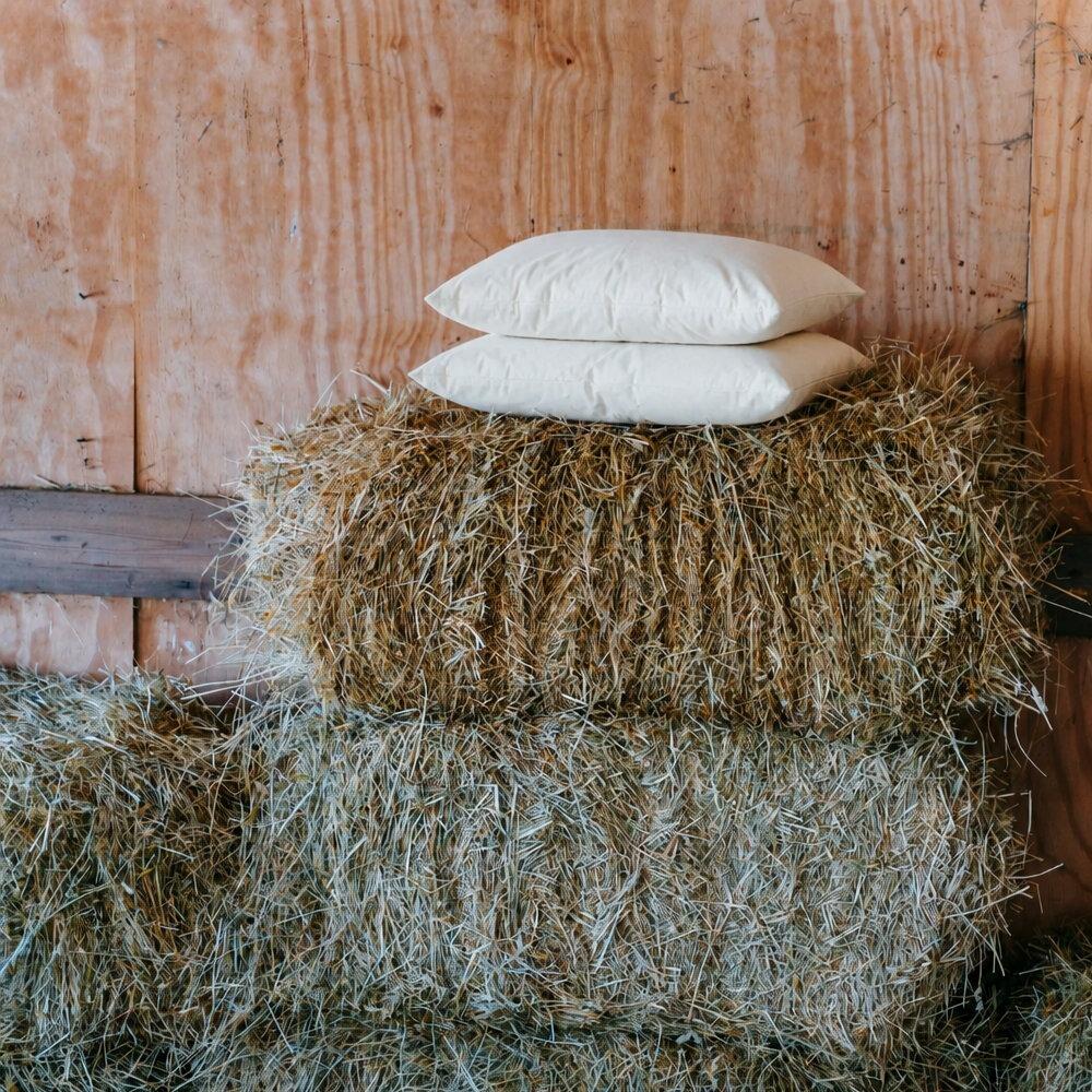 Rectangle wool cushion pad styled on the top of a hay bale