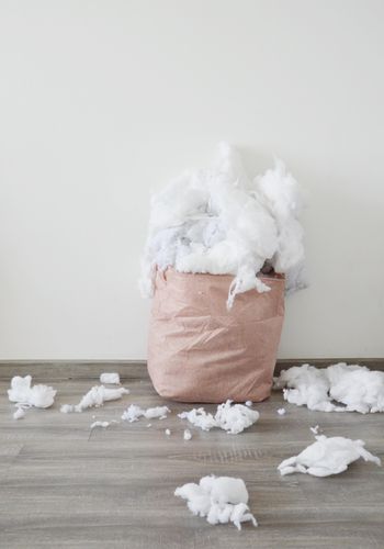 cushion filling in a sack spilling over the floor