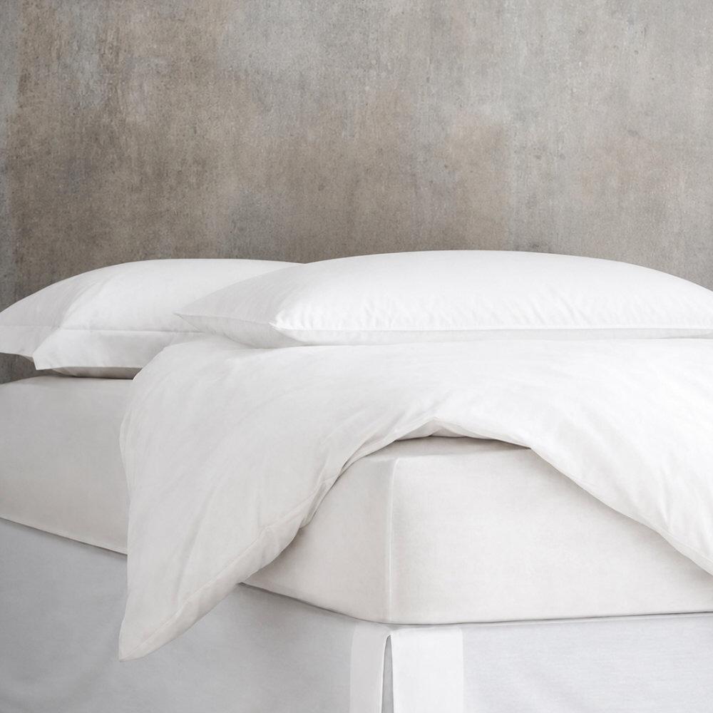 Adjustable fibre pillow styled on a bed