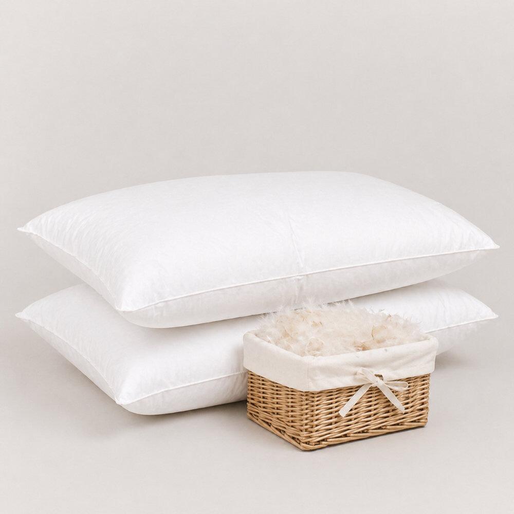 Pair of white down & feather pillows beside a basket of down & feather filling