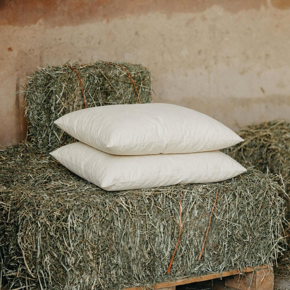 Rectangle wool cushion inserts styled on a hay bale
