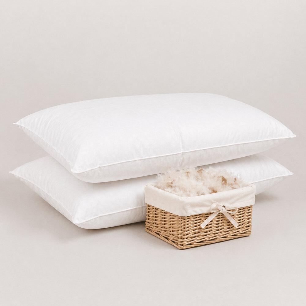Pair of white feather & down pillows beside a basket of feather & down filling