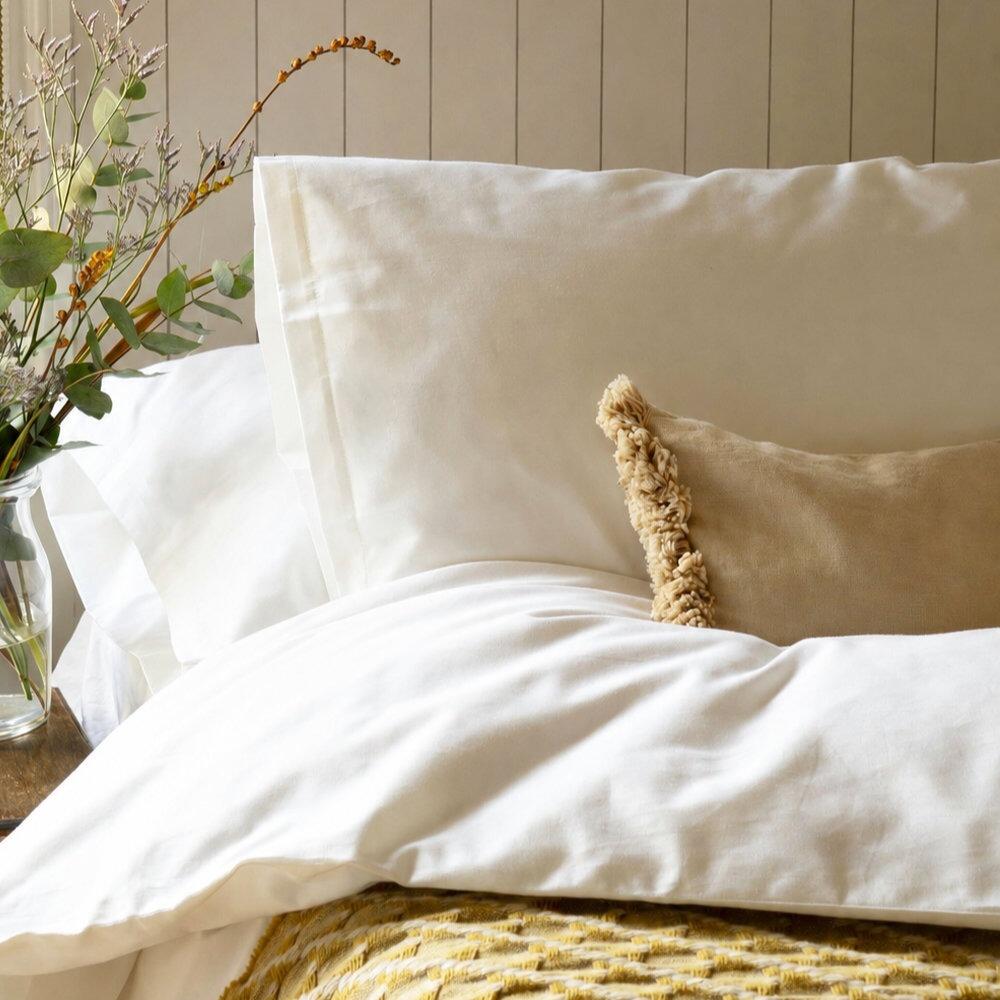 White standard pillowcases styled on a bed