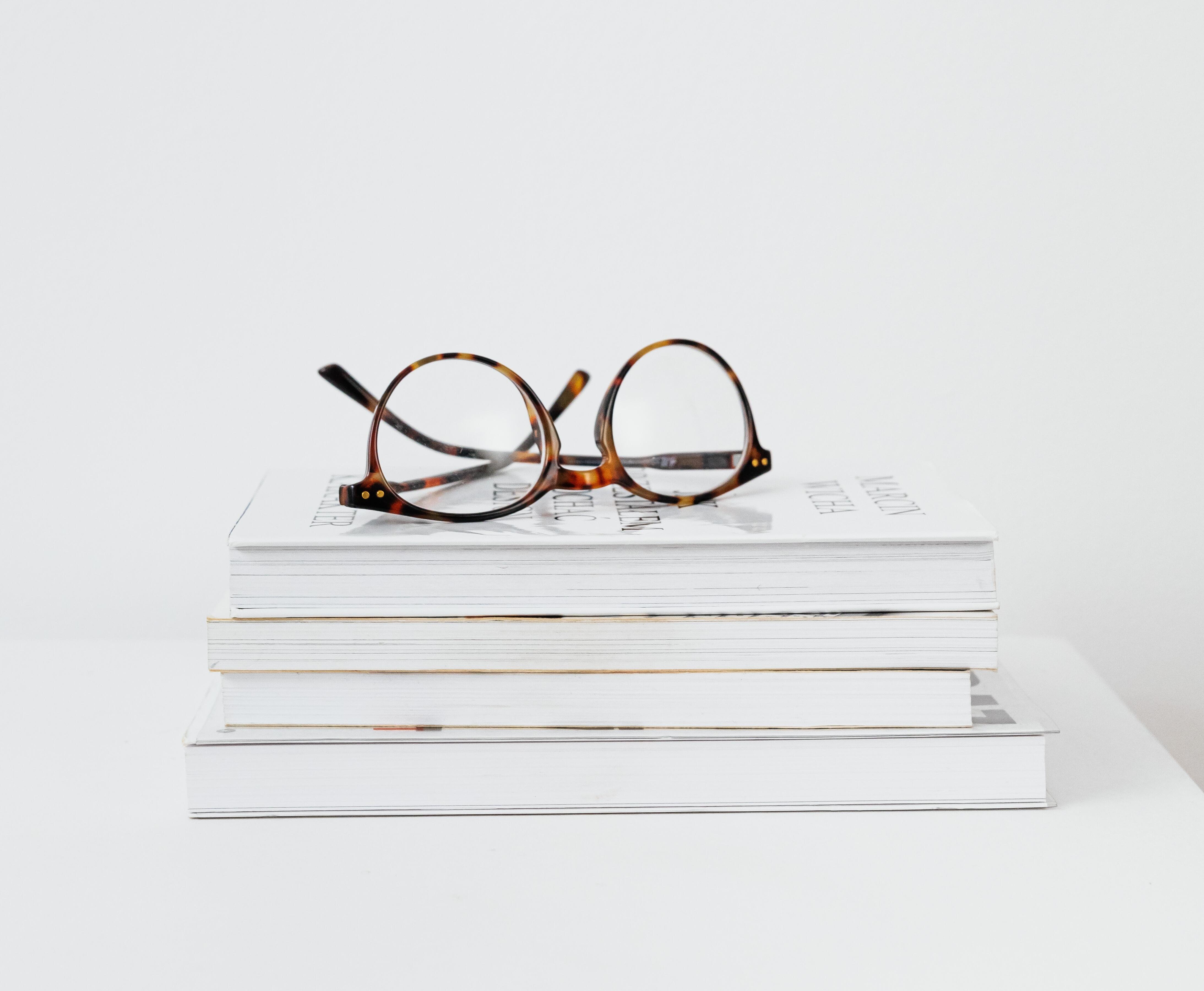 Prescription reading glasses on books