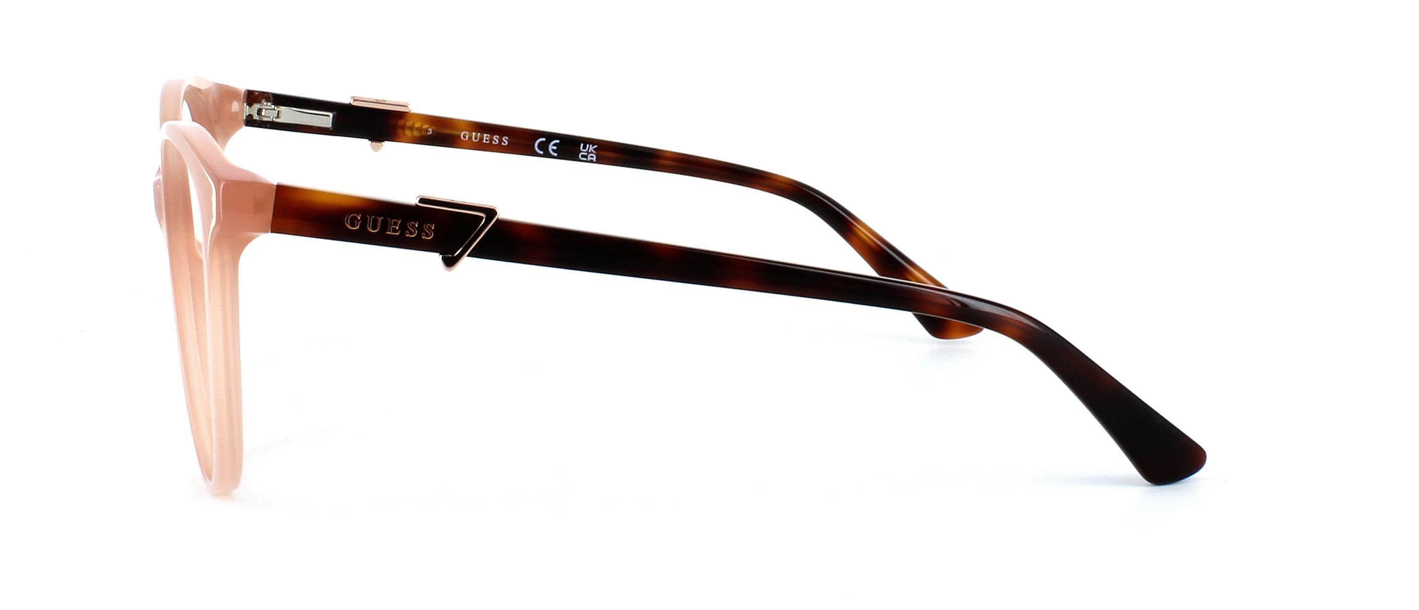 Guess 2877 - Ladies round shaped designer glasses frame with semi-transparent pale pink front face and sprung hinged shiny tortoise arms - image view 2