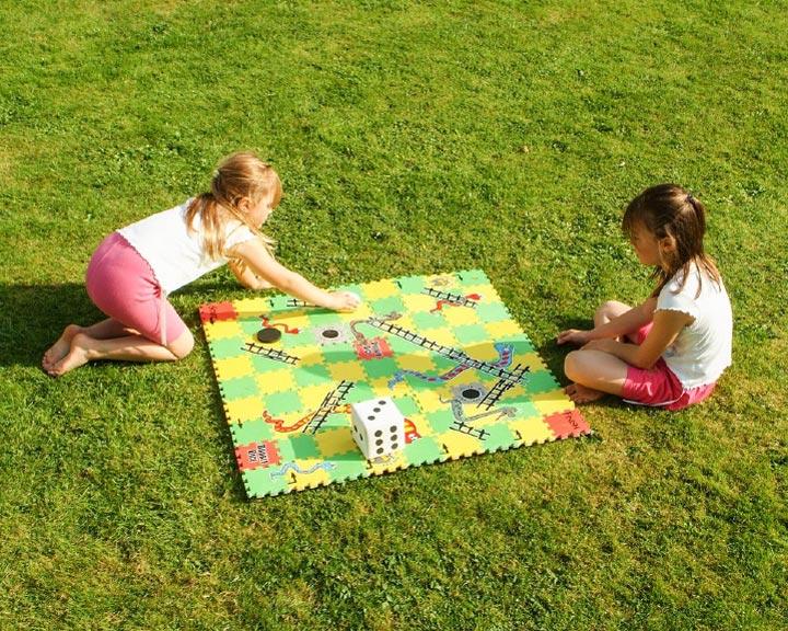 Children playing snakes and ladders