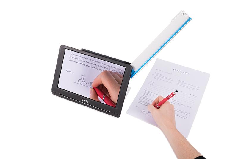 Compact 10 HD with its swing out arm open magnifing a document, the user is signing a document