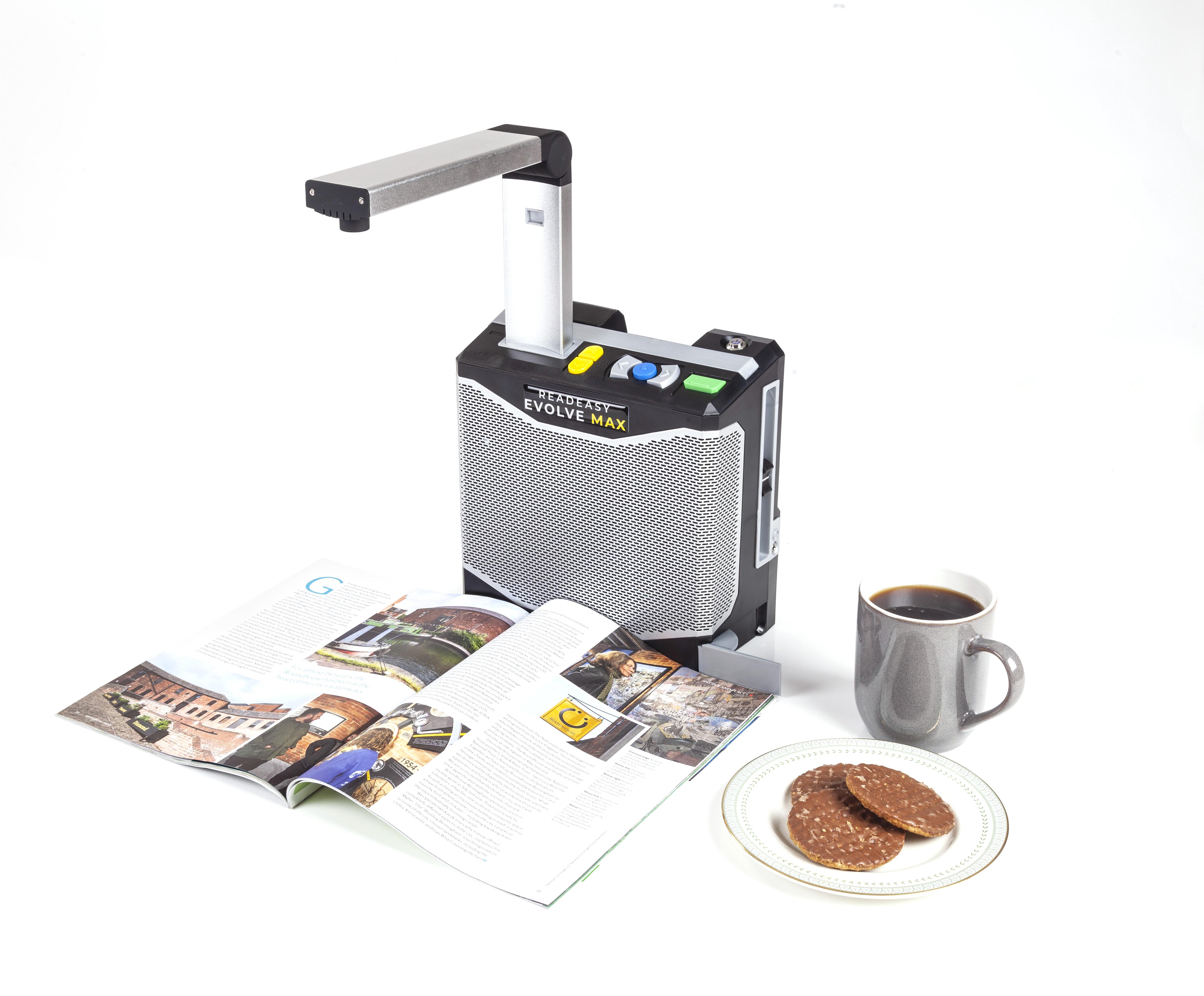 ReadEasy Evolve MAX capturing a magazine to the right of the readeasy evolve max is a grey mug of tea and a plate with 3 chocolate digestive biscuits