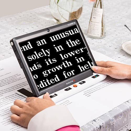 Sightcare Clover 10 magnifying printed text in enhanced colour mode, white on black
