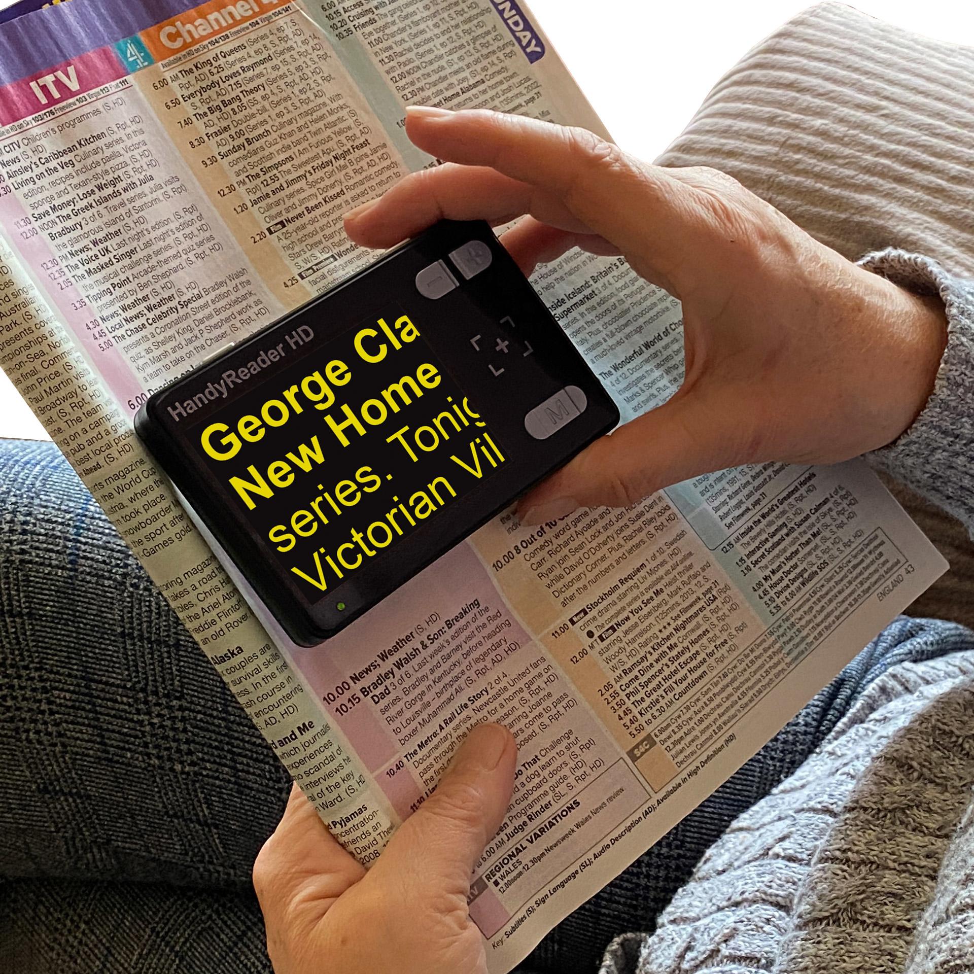 HandyReader HD magnifying a TV Guide, the text is yellow on a black background
