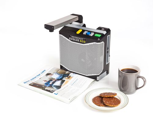 ReadEasy Evolve ECO capturing a book to the right of the ReadEasy evolve eco is a grey mug of black coffee a plate with 3 chocolate covered digestive biscuits