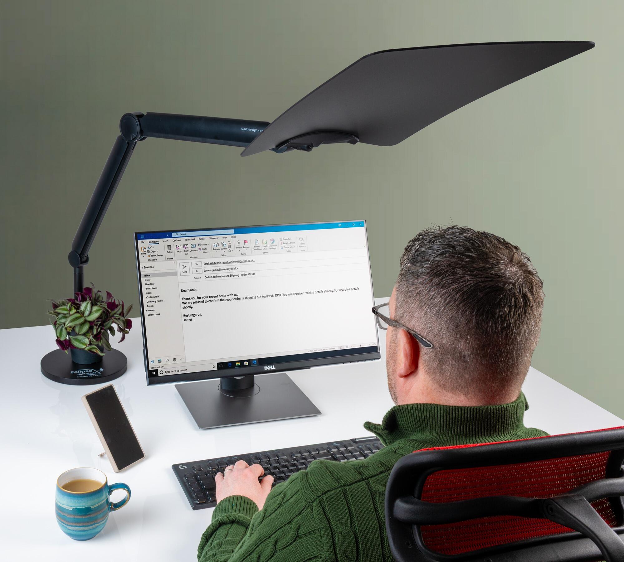 Eclipse Light Shield in an office setting mounted to its weighted with the light shield in a portrait position blocking light