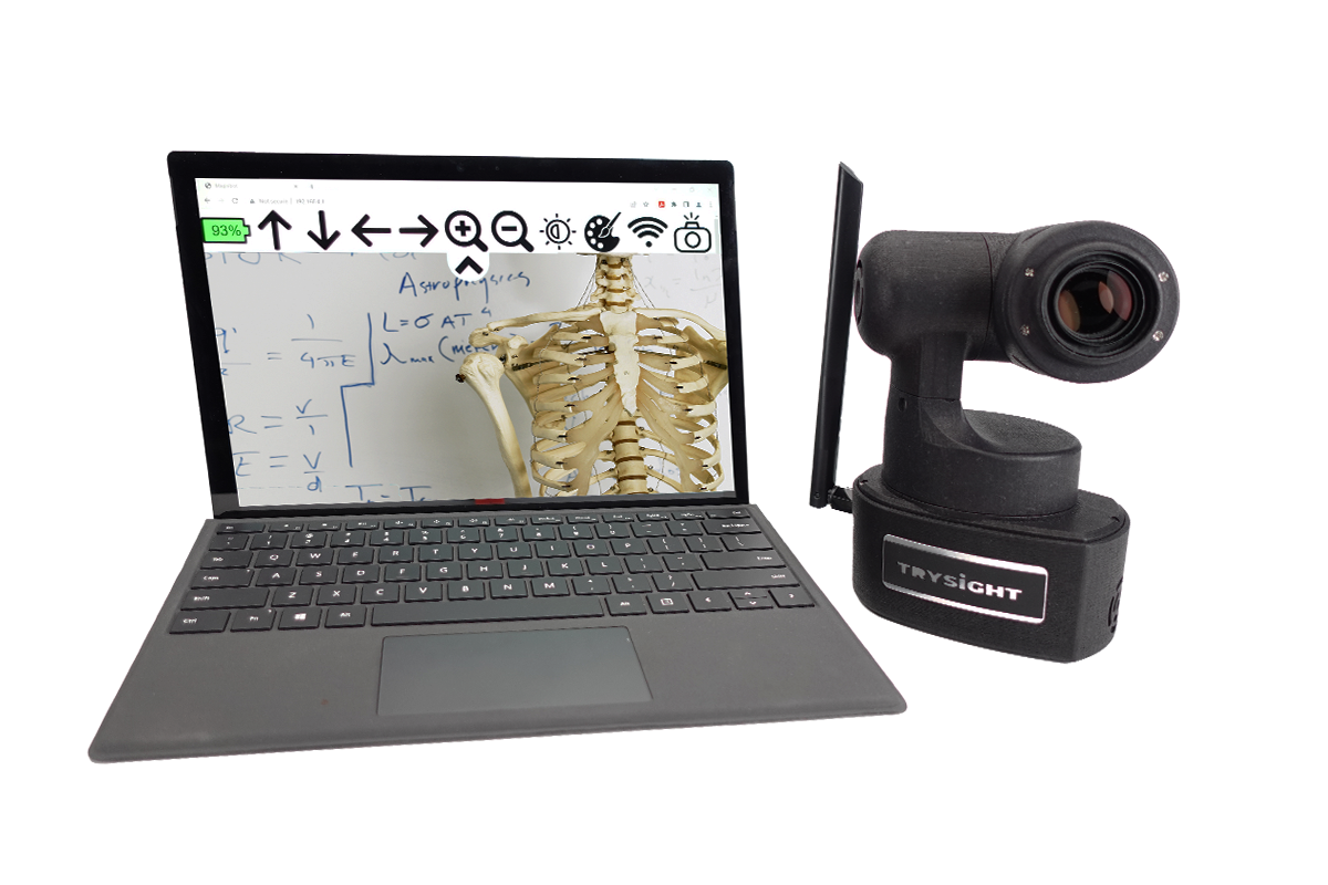 Magnibot next to a chromebook, on the screen of the chromebook you can see the navigation icons and an image of a whiteboard and the chest of a skeleton