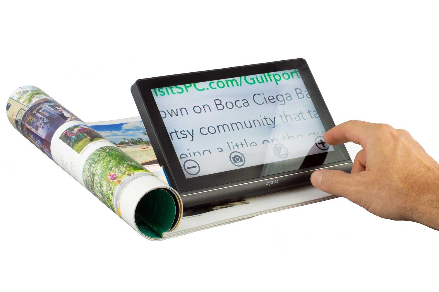 Compact 8 HD magnifying a page from a magazine