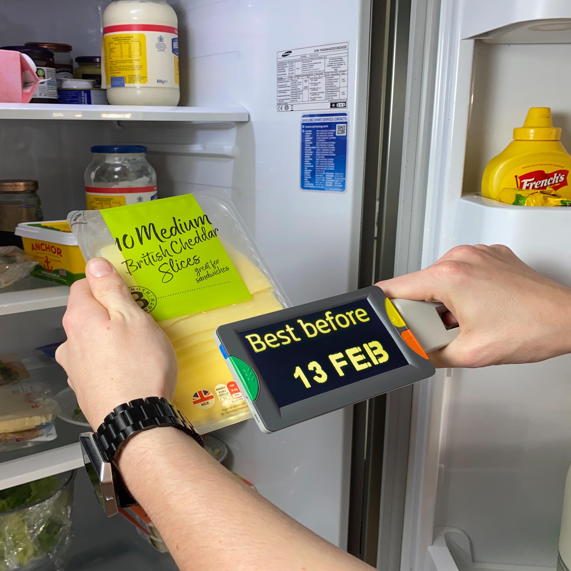 Eye-D v2 magnifying a best before date on a packet of sliced cheese, text shown in enchanced colours; yellow on black