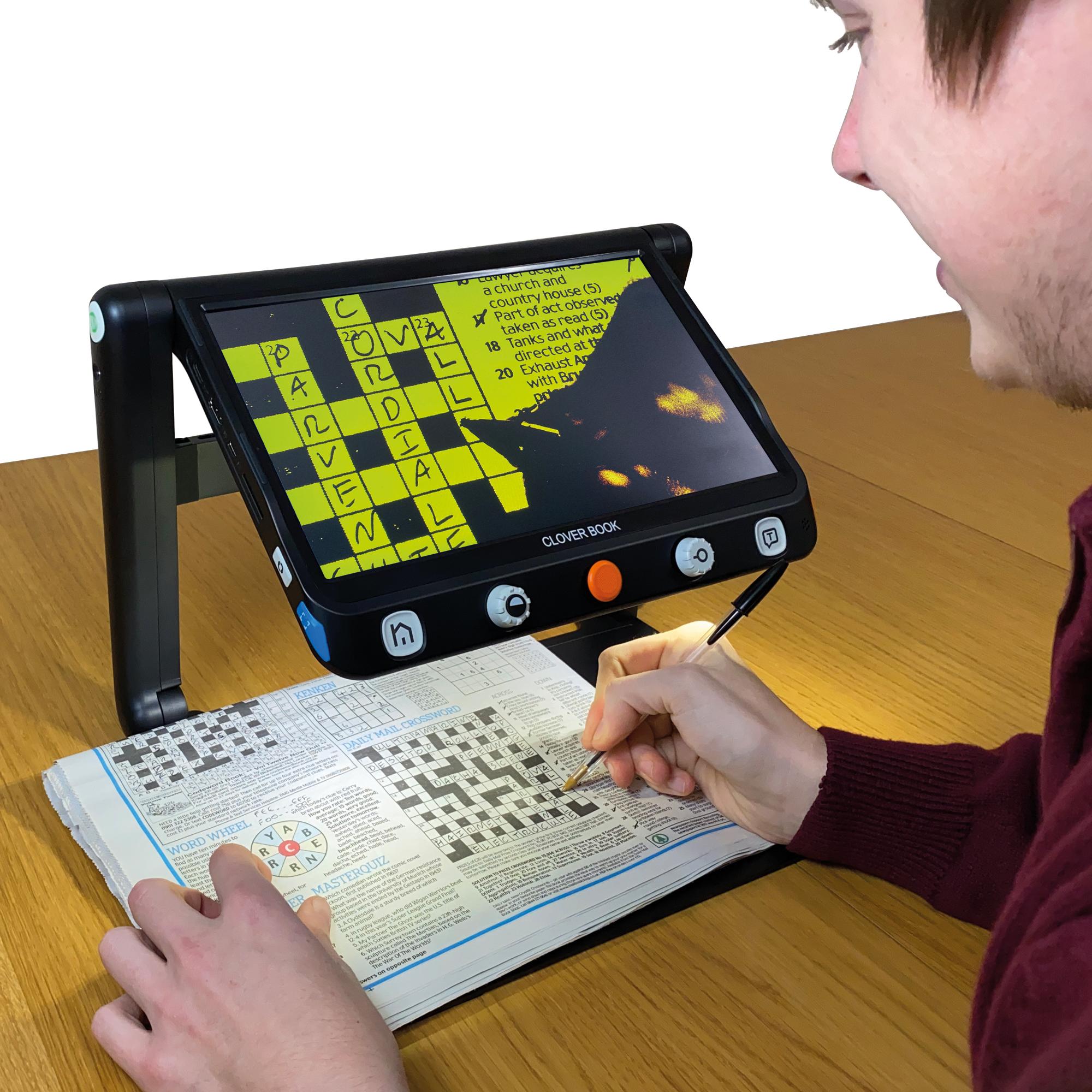 CloverBook magnifying a crossword with the screen showing an enhanced colour mode; black on yellow