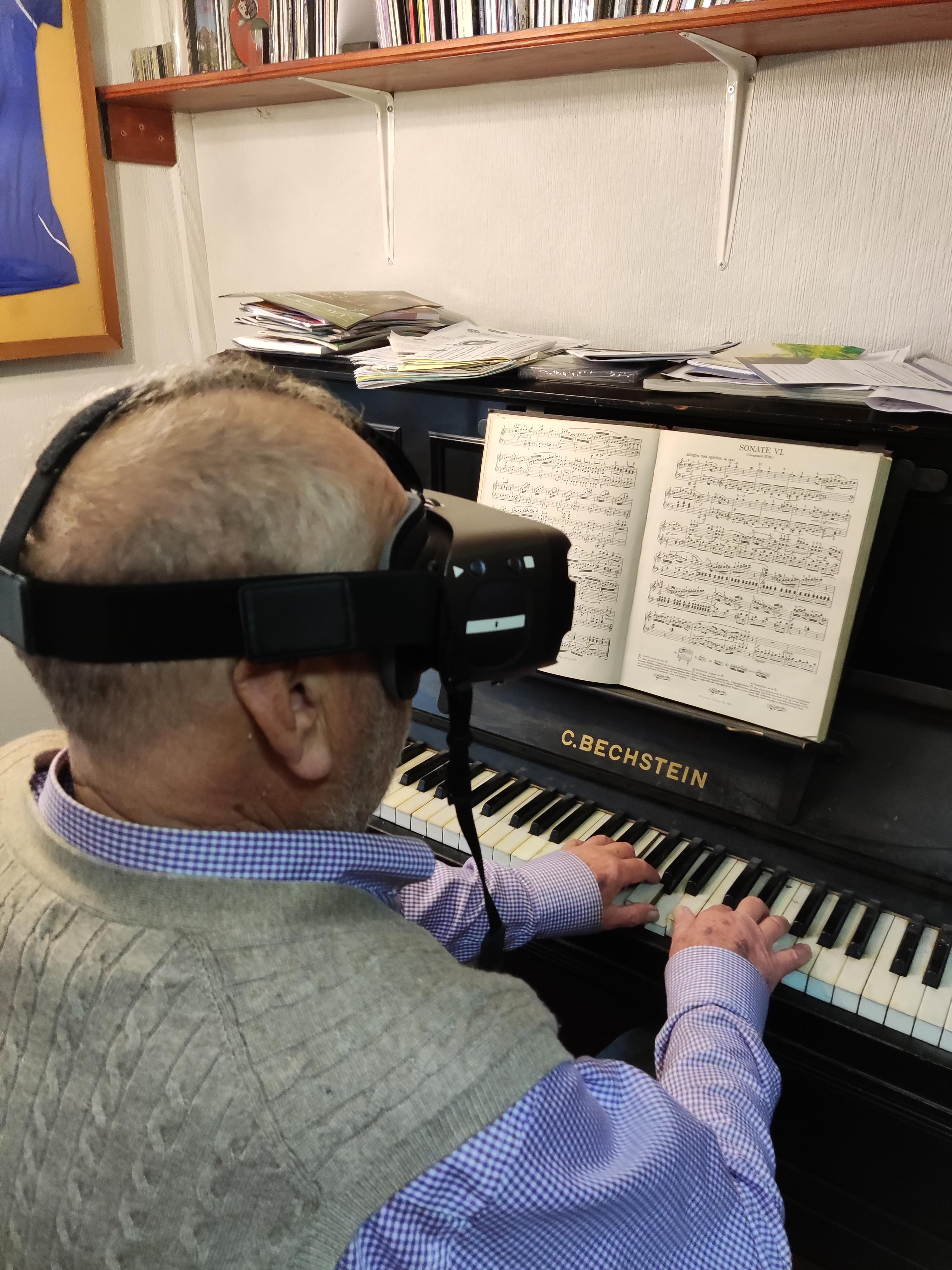 A man using his Irisvision to play the piano