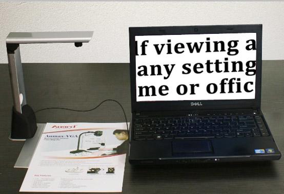 La Voice camera arm with a leaflet underneath, the text is shown on a laptop screen next to it