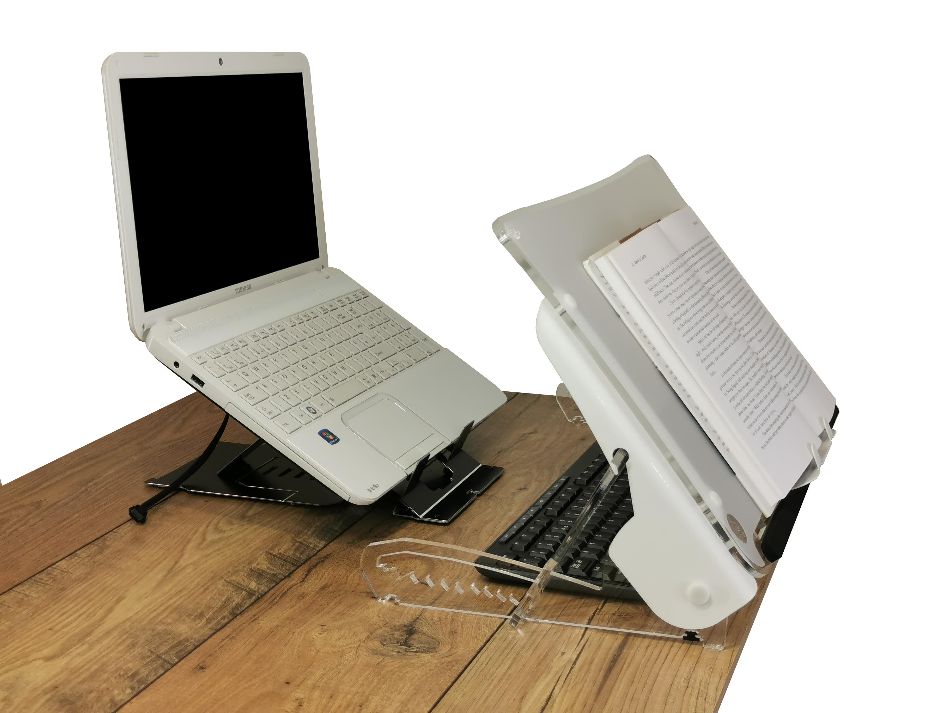 Clear Slope Pro Document Holder pulled forward on a desk over a keyboard with a book on the clear slope pro at it's highest position, there is a laptop on the desk