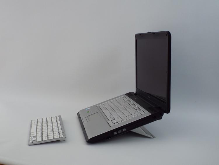 Side view of a Laptop on Shadow laptop stand at it's lowest position with keyboard in front