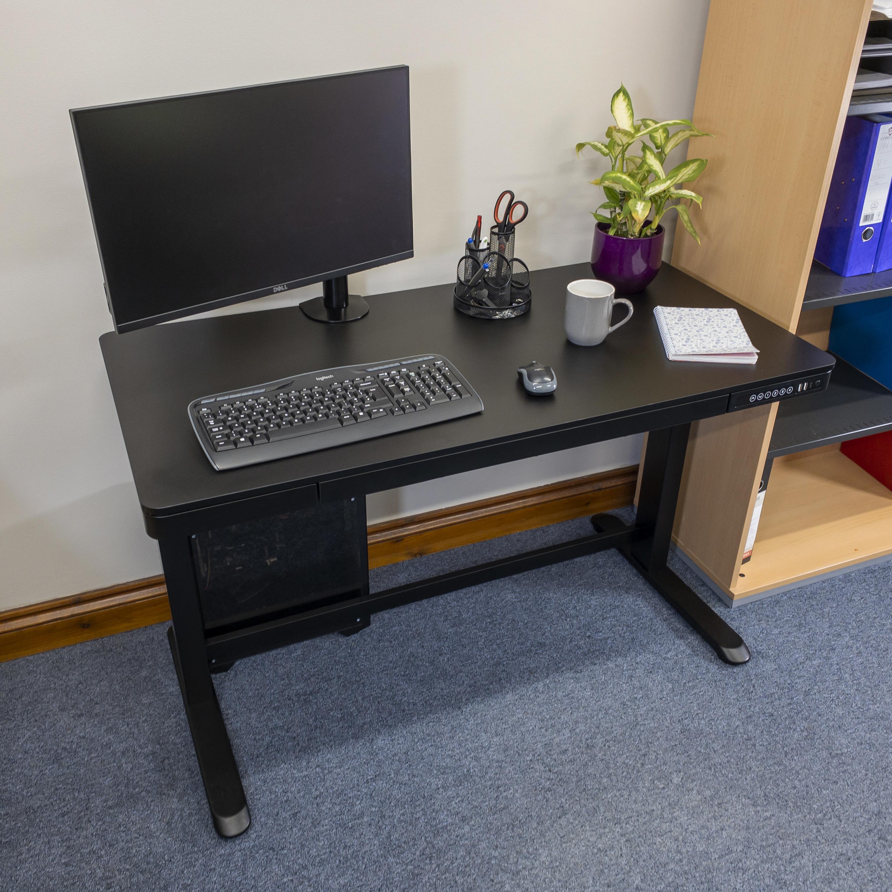 Elevate 120 sit stand desk in black with a monitor and VTArm, Bluetooth keyboard and mouse.