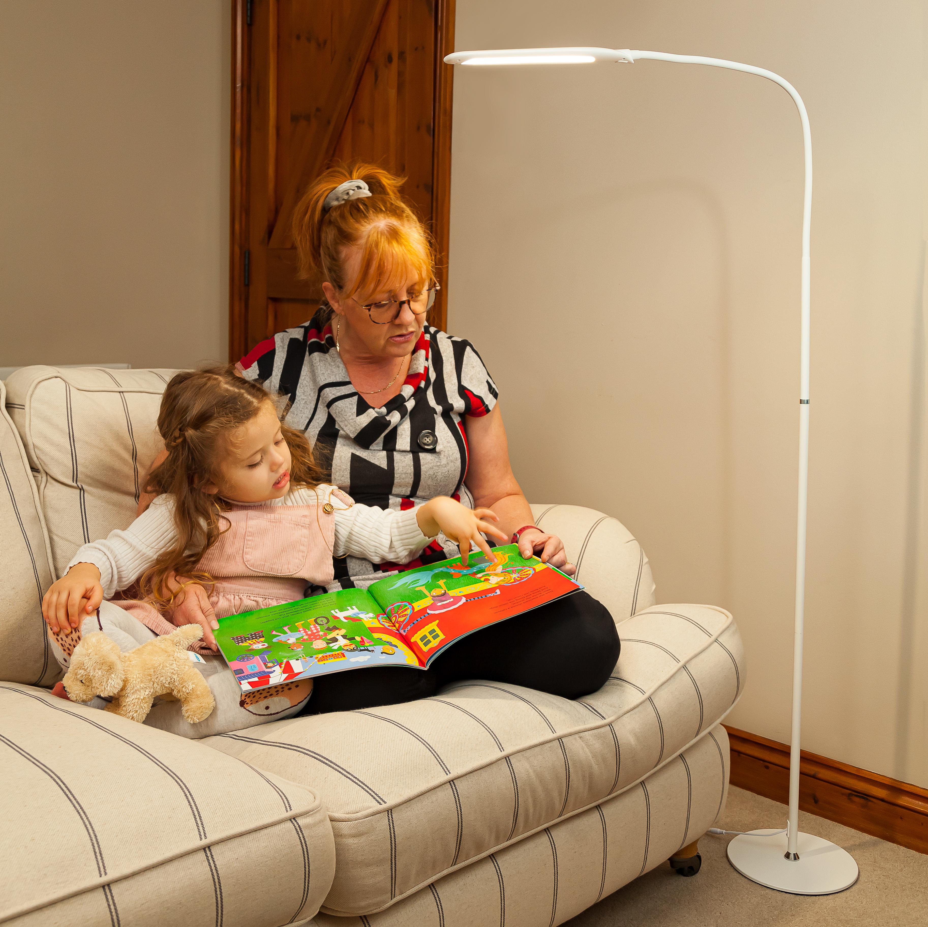 StandBright 2 Floor Standing Light shining over a mother and daughter reading a picture book together
