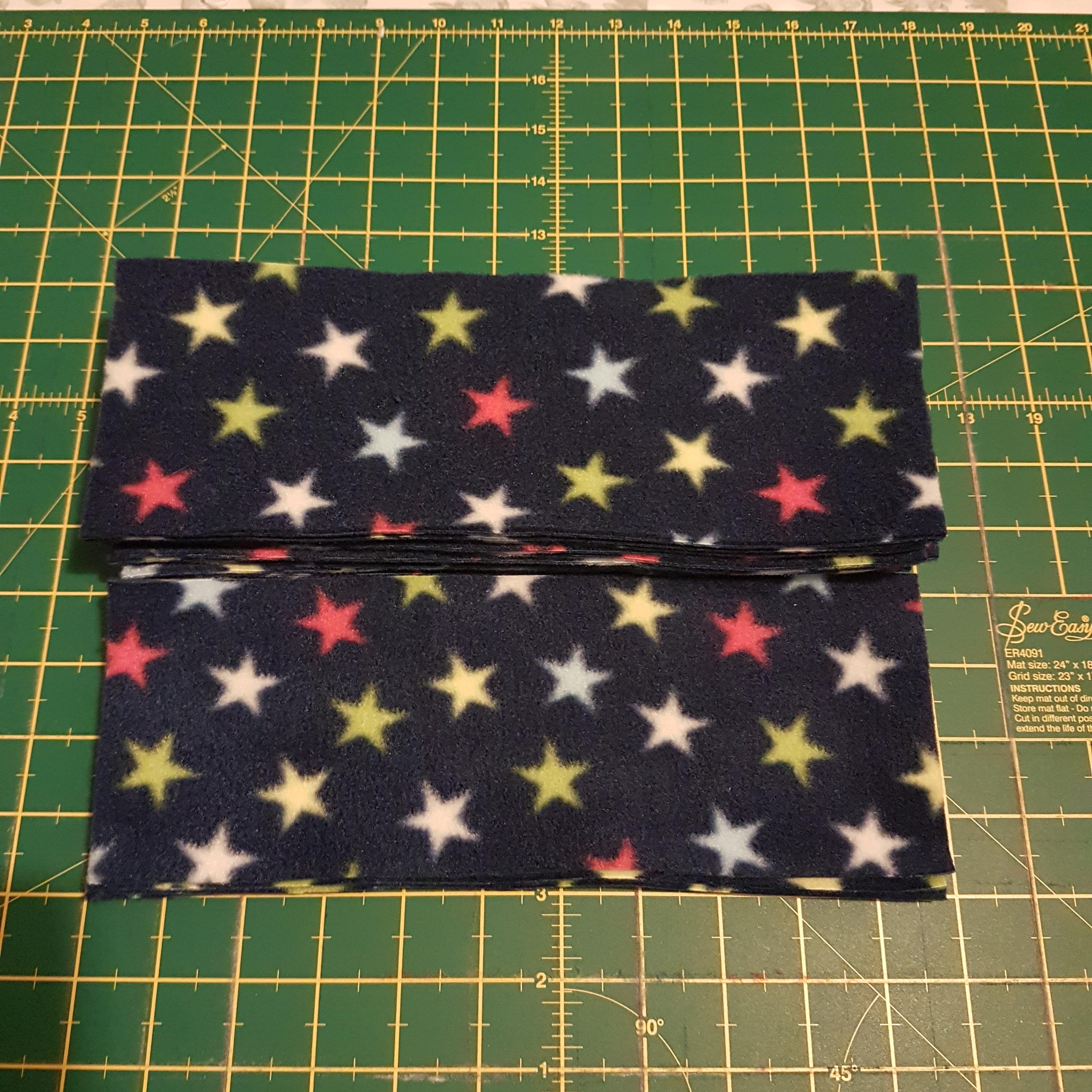 Image of a pile of star pattern rectangular fleece nappy liners