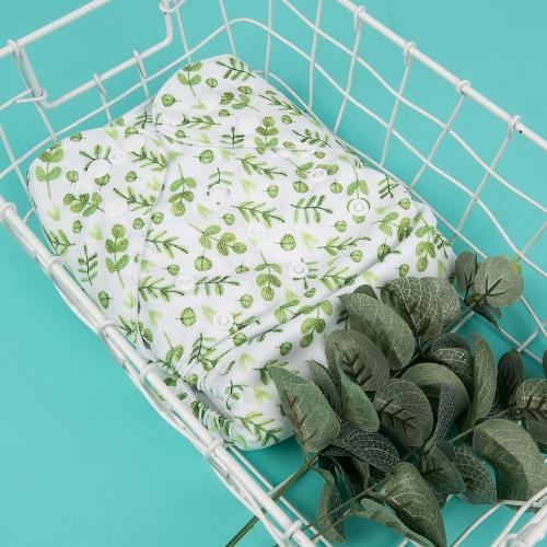 white pocket nappy with a variety of small green leaves in a white basket