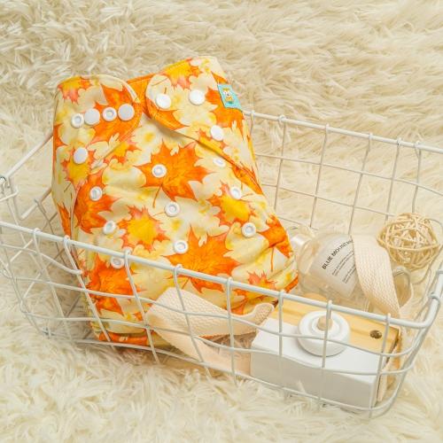 Light Yellow pocket nappy with yellow and burnt orange leaves in a white basket