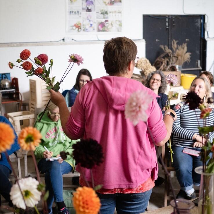 Claire using seasonal flowers to make a bouquet