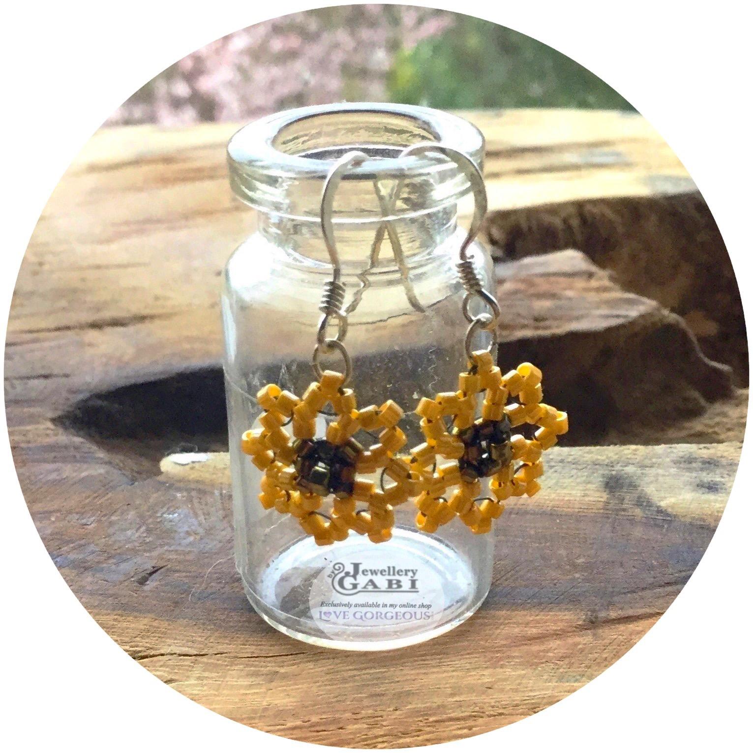 Jewellery by Gabi dinky beaded sunflower earring hanging on glass bottle