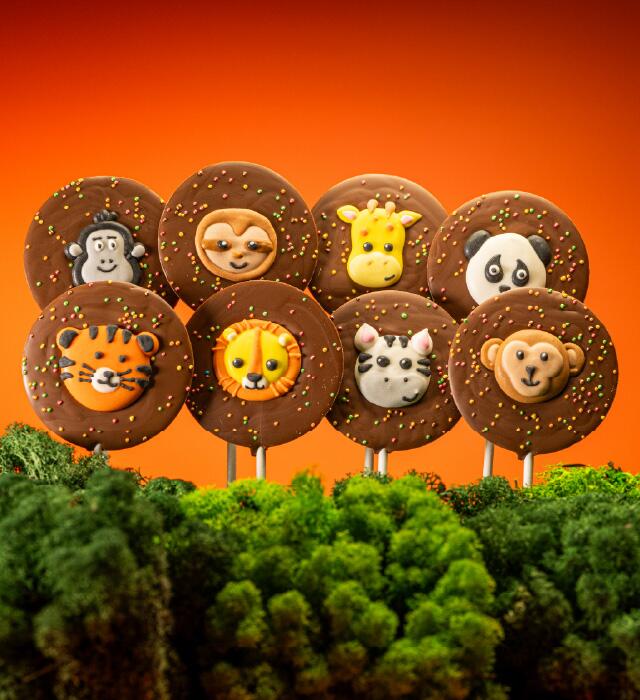 A set of Zoo themed iced animal toppers and sprinkles on milk Belgian chocolate lollies.