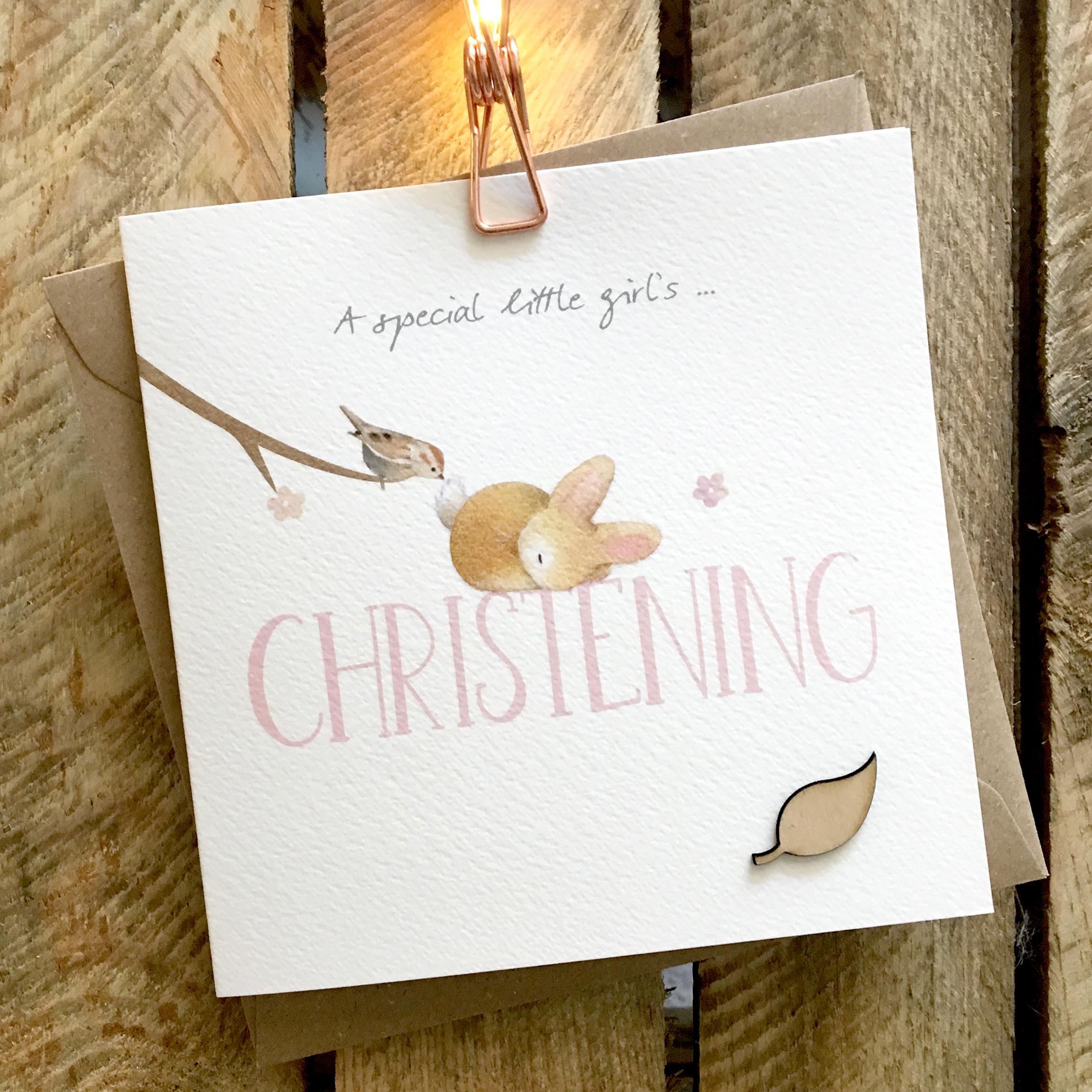 Card featuring a fluffy baby rabbit and small bird on top of a large pink CHRISTENING caption