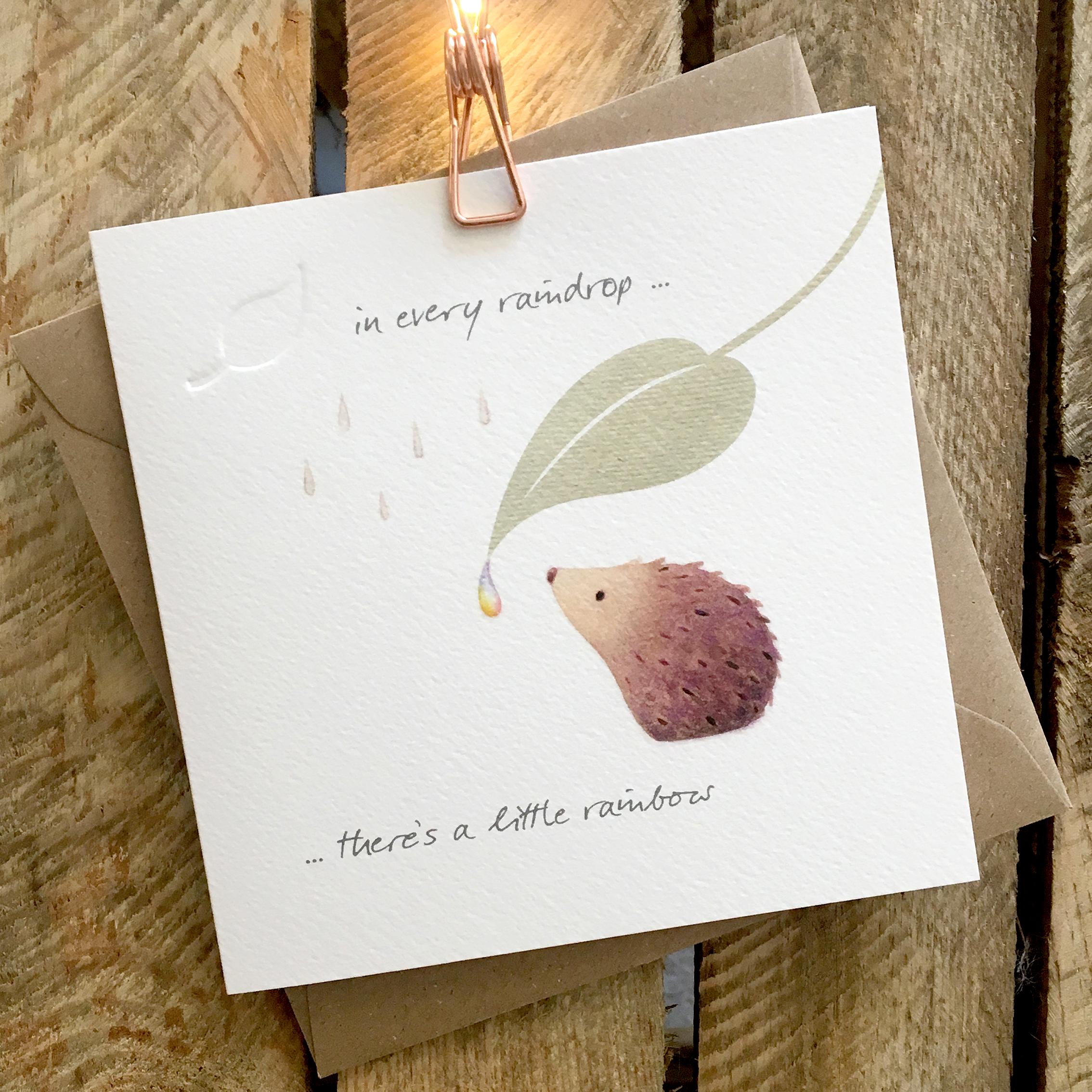 Card featuring a cute hedgehog sheltering from raindrops under a large leaf