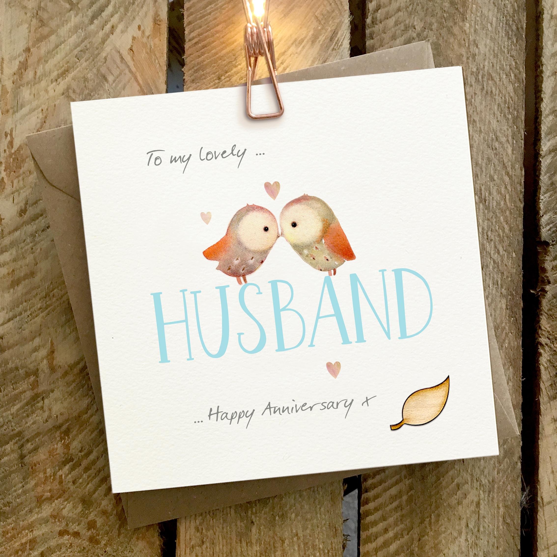 Card featuring two cuddling owls sitting on top of a large HUSBAND caption
