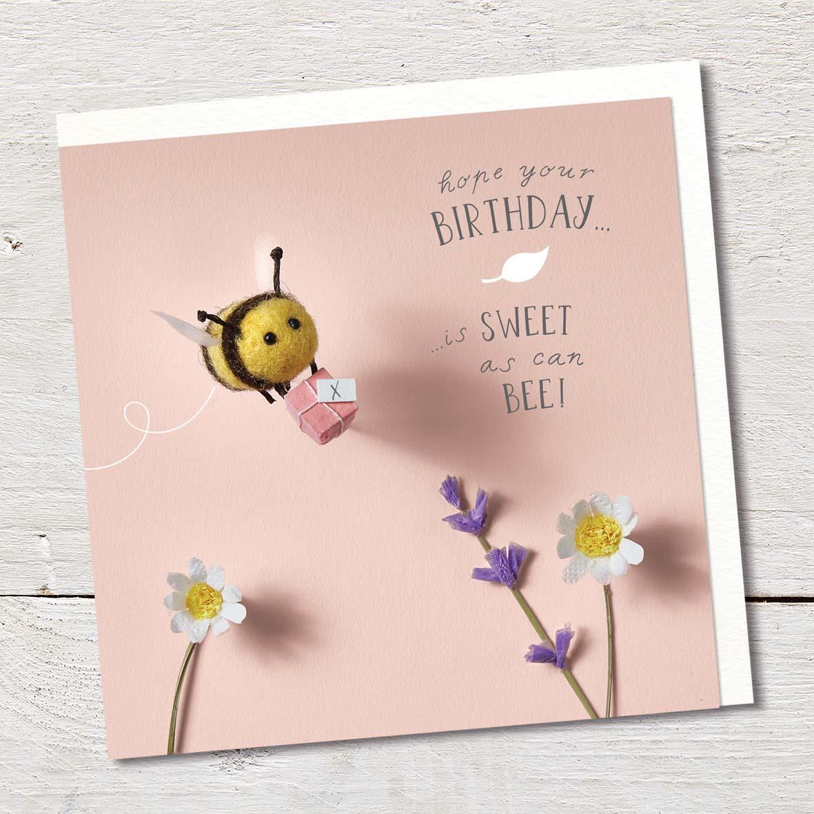 Card featuring flowers and a cute felted bumble bee carrying a tiny present.