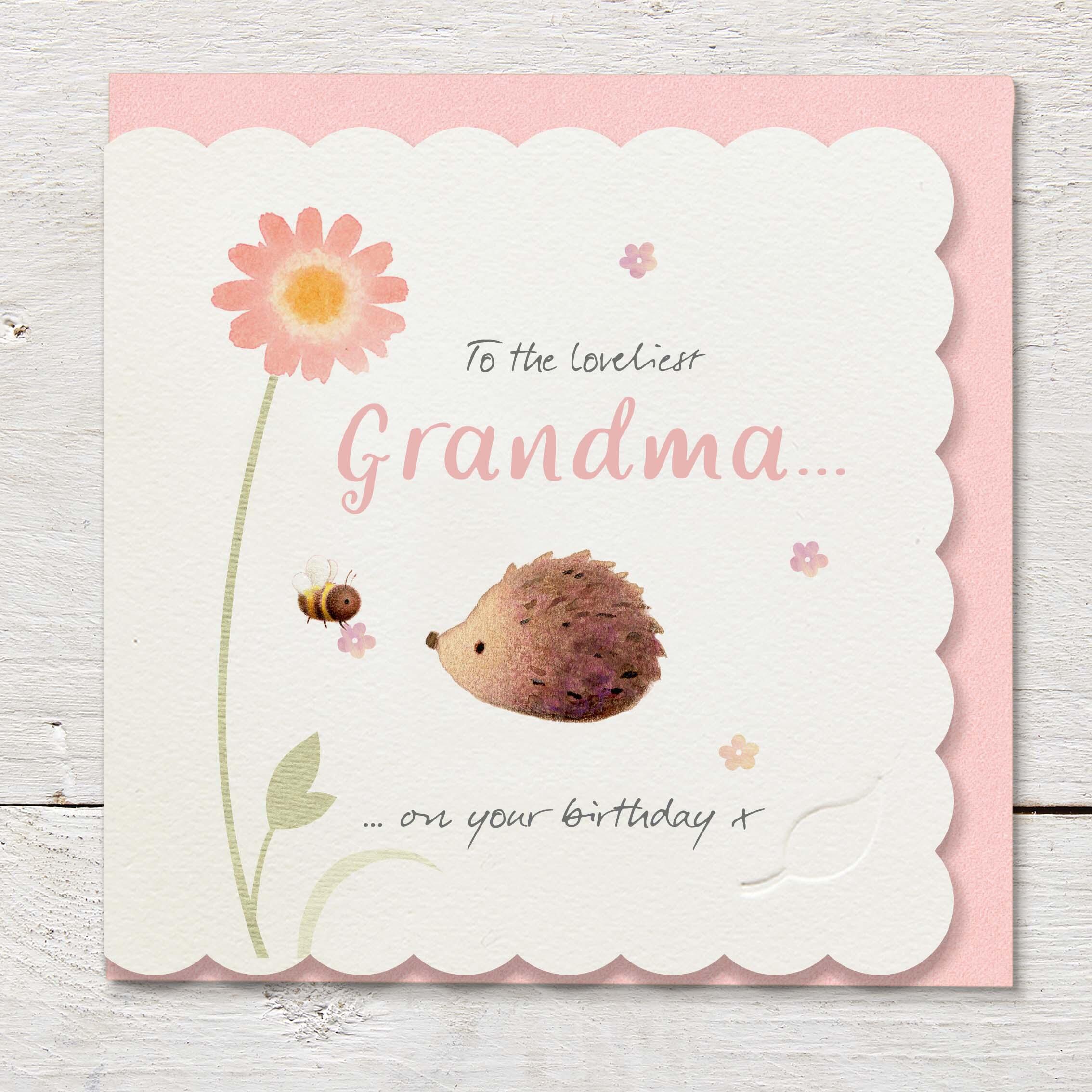 Die cut cardfeaturing a large pink daisy, hedgehog and bumble bee.