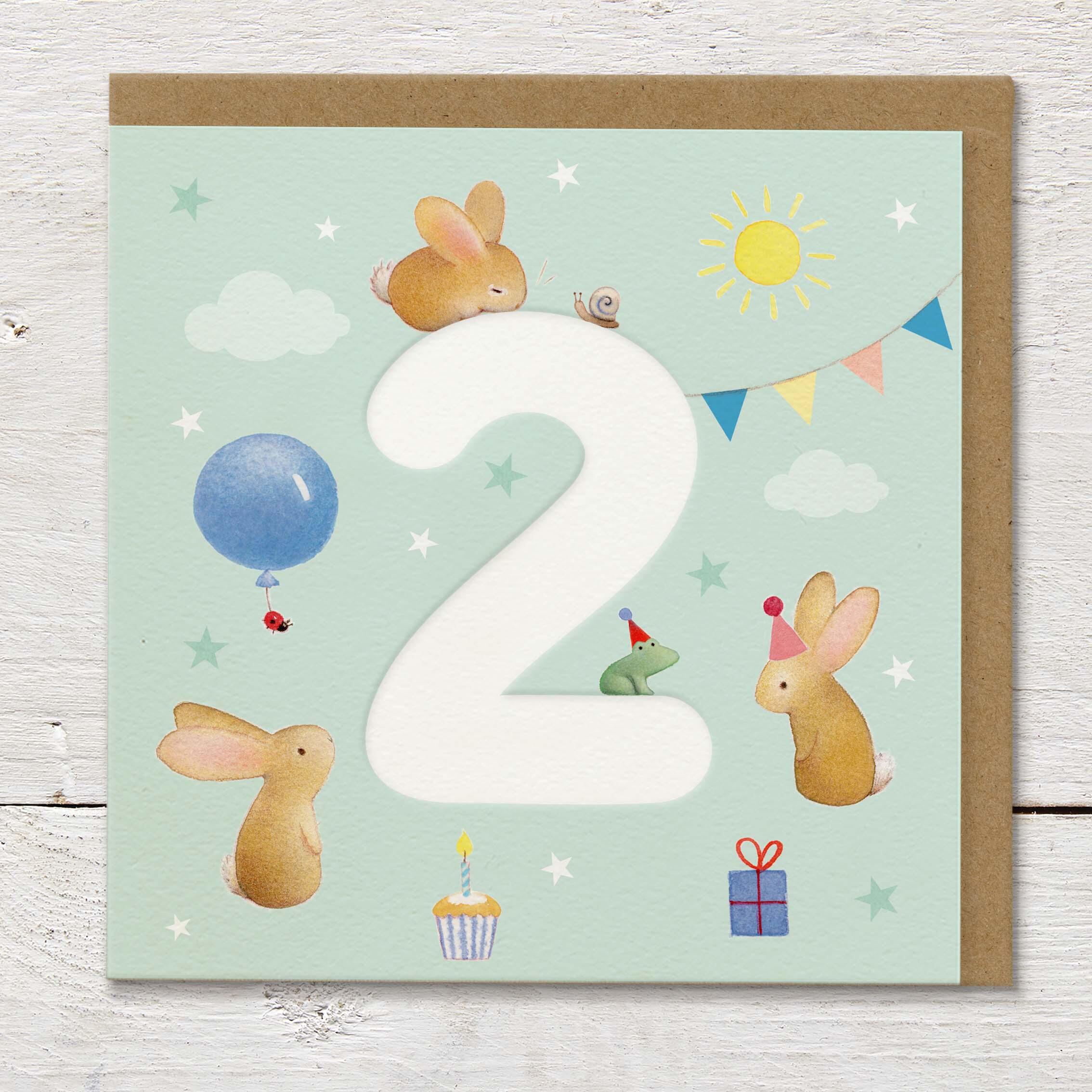 Children's age card featuring a large debossed age 2 surrounded by cute rabbits and party elements on a pale green background.