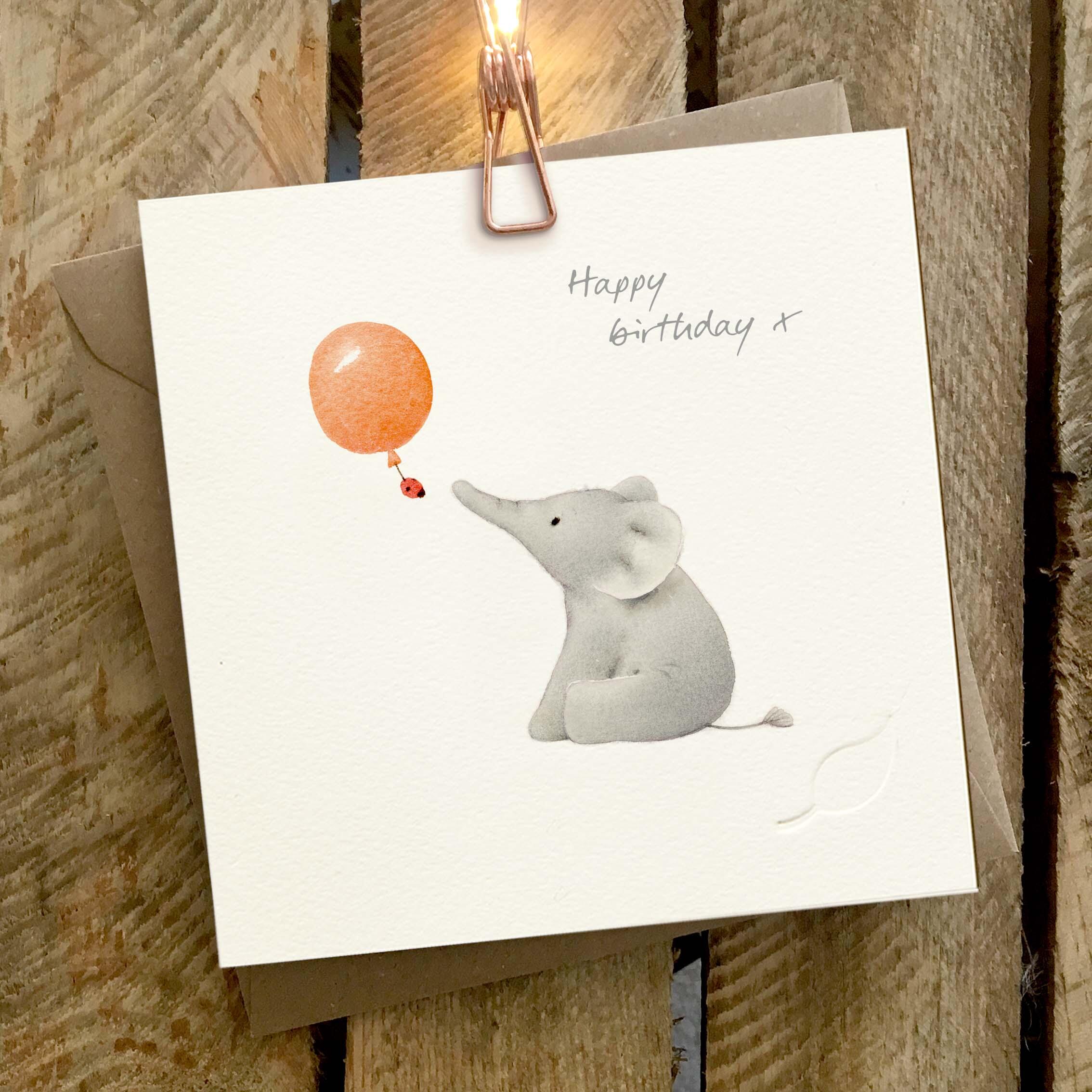 Elephant Family - Charity greeting card featuring a cute illustrated elephant, and a red balloon with a little ladybird beneath.