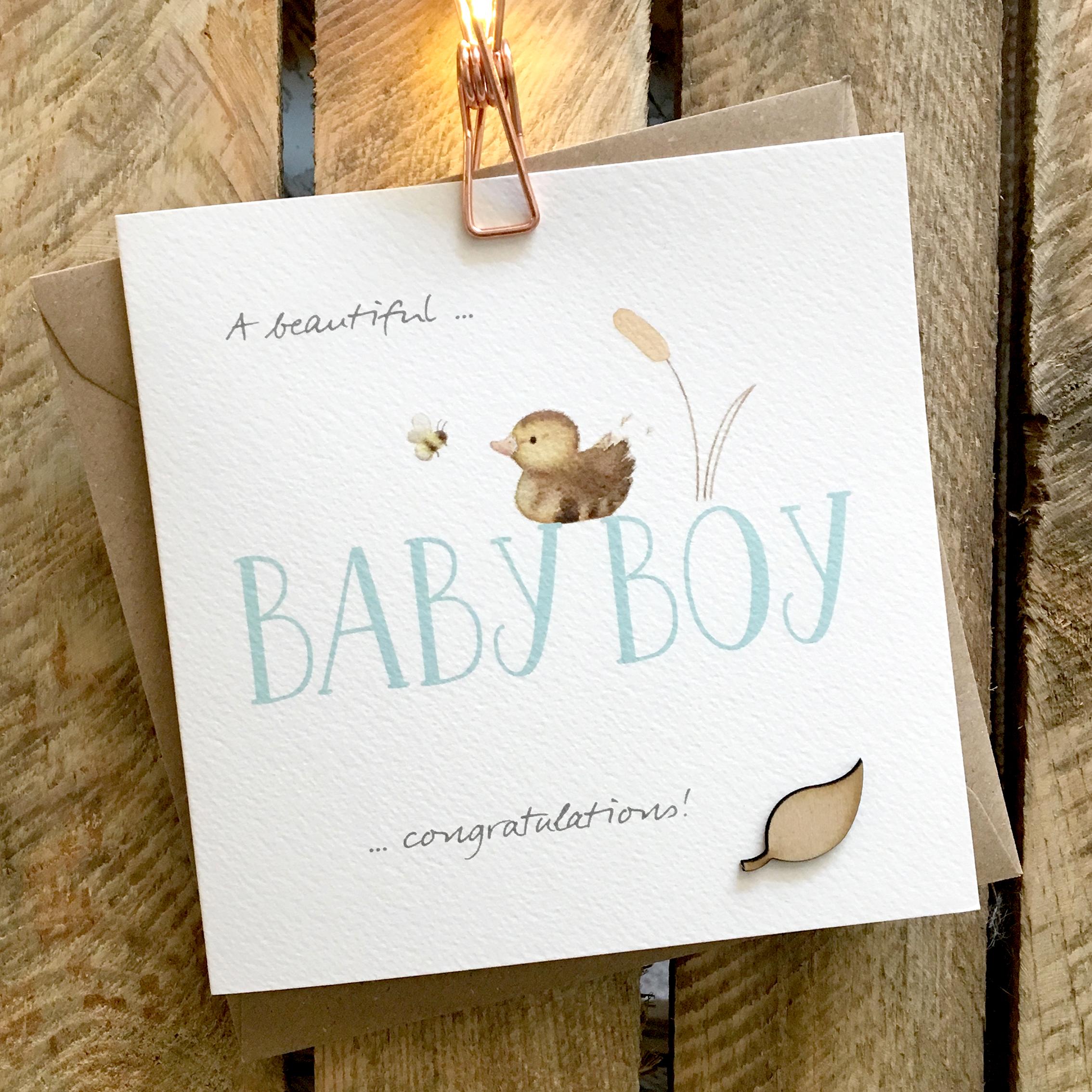 Card featuring a cute fluffy duckling and bumble bee sitting on top of a large blue BABY BOY caption